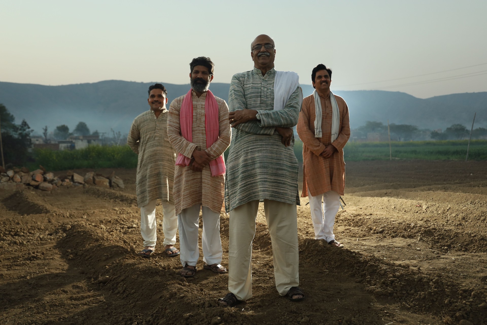 Beautiful composition of Happy Indian farmers standing together in the farm land. Four farmers standing together in the field.